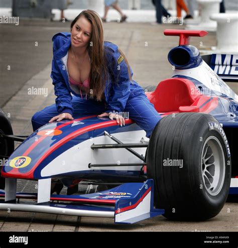 Racing cars and sex A model poses for photographers on the bonnet of a ...