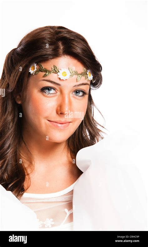 An Eighteen Year Old Brunette Woman In A White Sun Dress With A Flowered Headband In Studio Over