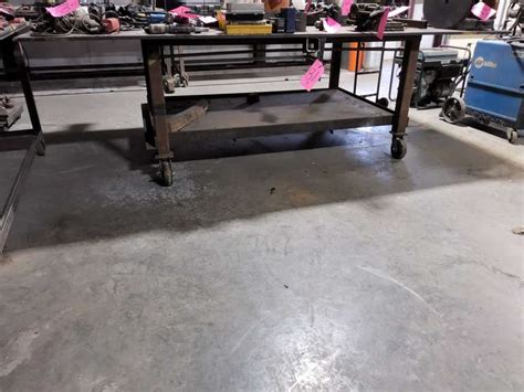 Metal work table on wheels 5'x10' w/ 3/4" top - Lindsay Auctions LLC