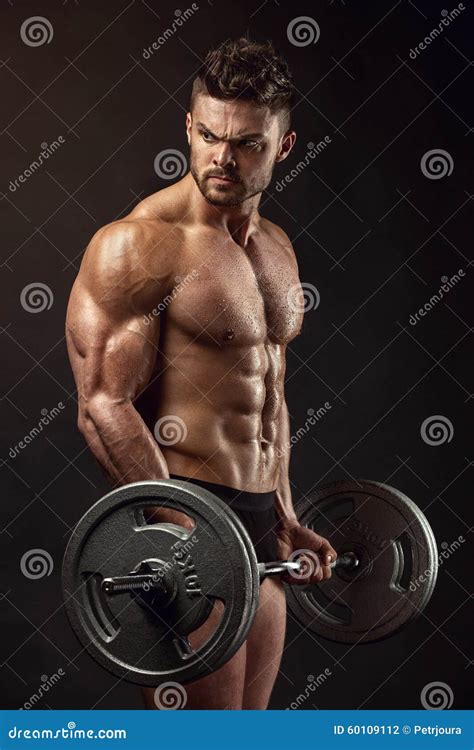 Muscular Bodybuilder Guy Doing Exercises With Big Dumbbell Stock Photo