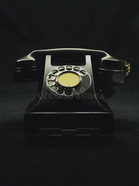 Old telephone. Old style black vintage telephone on black background ...