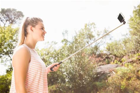 Smiling Pretty Blonde Taking Selfies With Selfiestick Stock Photo Image Of Holding Beautiful
