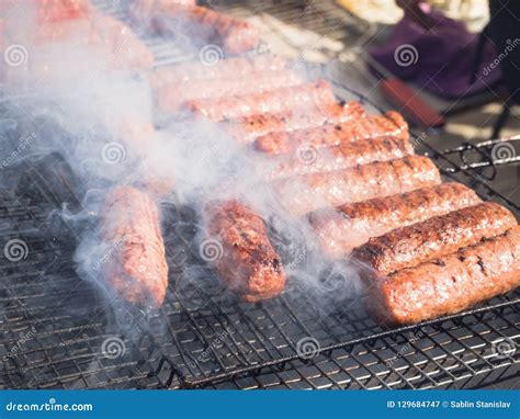 Romanian Mititei and Cooked on the Grill in the Smoke. Stock Image ...