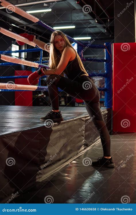 Blonde Caucasian Fighter Girl In Red Boxing Gloves Is Posing On Fight Club Boxing Ring Stock