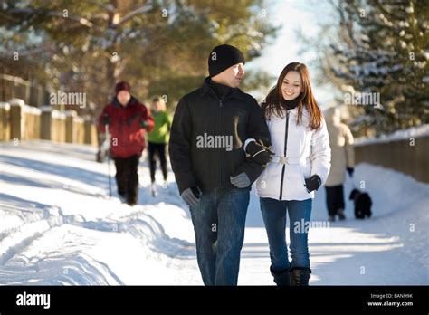 Couple walking on winter paths Stock Photo - Alamy