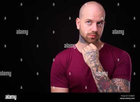 Handsome Bald Bearded Man Against Black Background Stock Photo Alamy