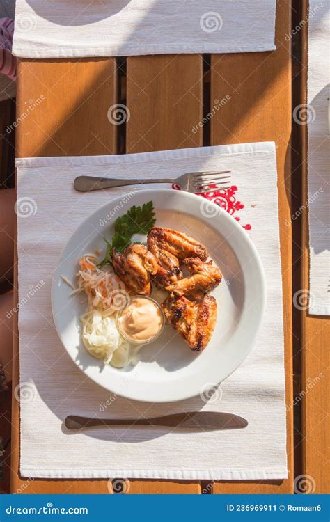 Beautifully Served Table Grilled Chicken Wings With Vitamin Salad Of White Sauerkraut Top View