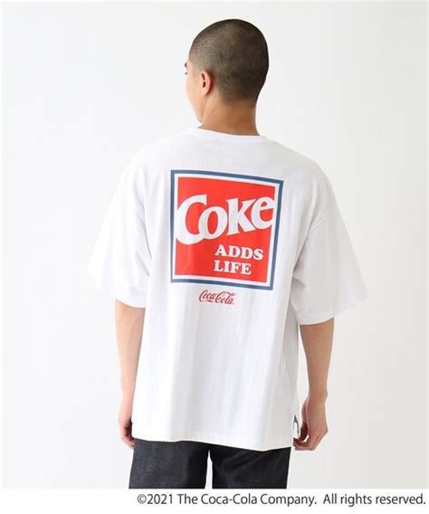 Coca Cola（コカコーラ）の「 Coca Colaコカ・コーラ ドリンクレトログラフィック 別注コットン半袖tシャツ（tシャツ