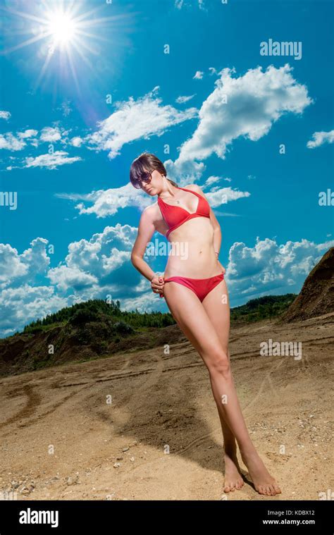 Brunette In A Red Bikini On A Sunny Day In The Sand Stock Photo Alamy