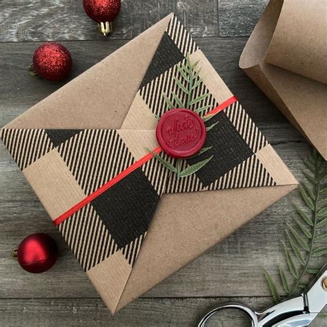 A Christmas Present Wrapped In Brown Paper With A Red Wax Stamp On It