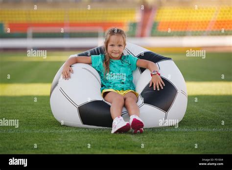 little funny girl on football stadium Stock Photo - Alamy