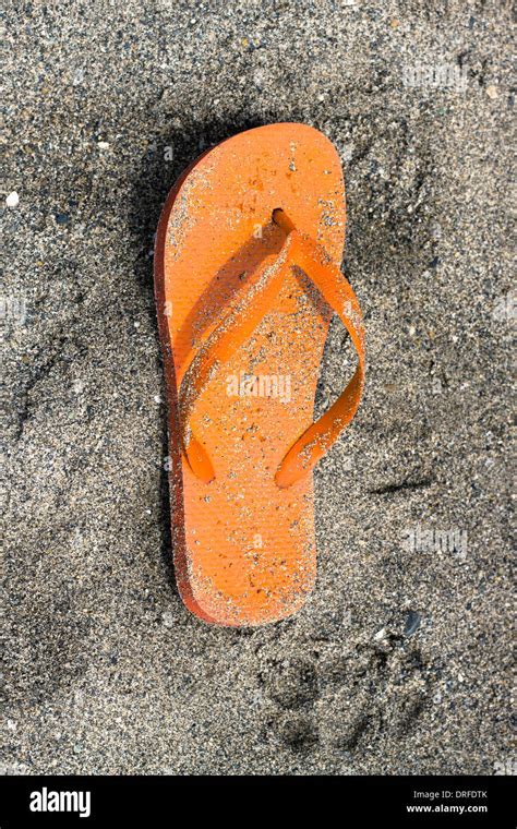 Orange Flip Flop On Sandy Beach Stock Photo Alamy