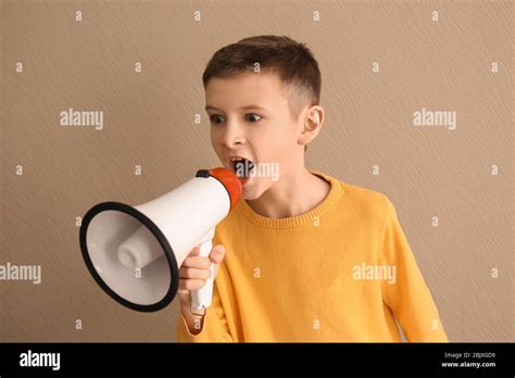 Emotional Little Boy With Megaphone On Color Background Stock Photo Alamy