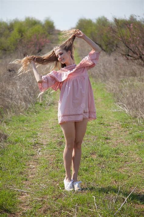 Beautiful Blonde Woman In Pink Dress In Green Flowering Garden In Spring Stock Photo Image Of
