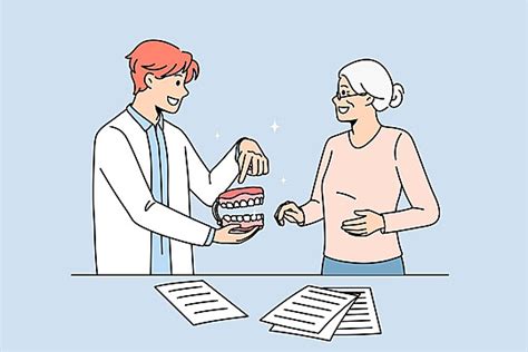 Female Patient Receiving Consultation From Male Doctor At Reception