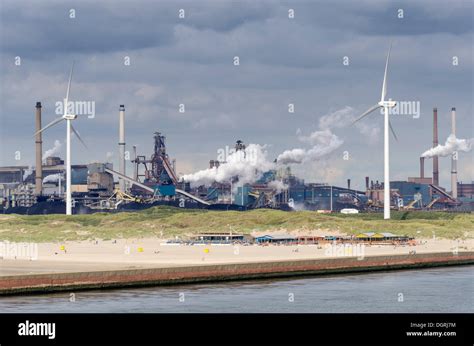 The sandy beach near Wijk aan Zee with beach pavilions, wind turbines ...