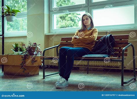 Young Anxious And Depressed Female College Student Sitting In The