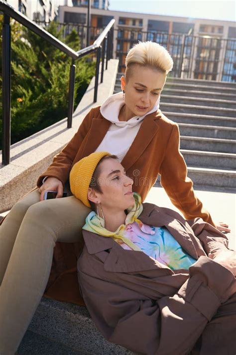 Blonde And Brunette Chatting And Relaxing On Steps Of City Stairs Stock Photo Image Of