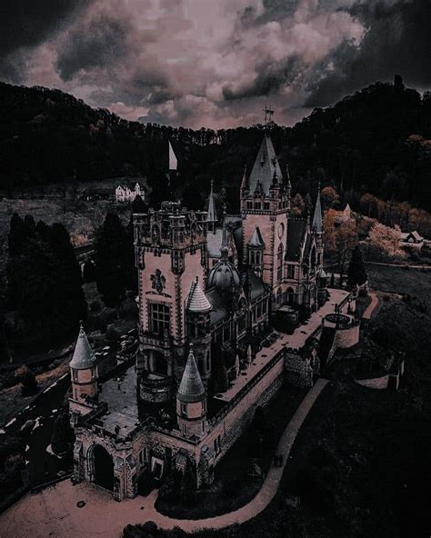 An Aerial View Of A Castle With Dark Clouds In The Background