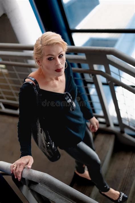 Attractive Blonde Woman Walking Down A Flight Of Stairs In A City Building Stock Photo Image