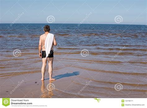 Middle Aged Man With A Naked Torso Standing On The Beach Stock Image Image Of Daytime