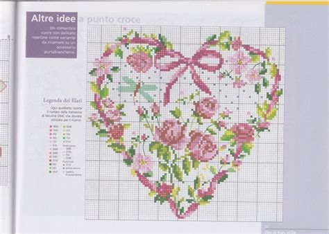 A Cross Stitch Heart With Pink Flowers On It