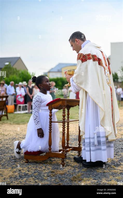 A Child Receiving The First Holy Communion Stock Photo Alamy