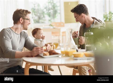 Caucasian Gay Fathers And Baby Eating Breakfast Stock Photo Alamy
