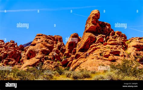 The Erratic Red Aztec Sandstone Formation Near The Arch Rock Campground Under Clear Blue Sky In