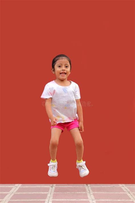 Year Old Latina Girl Jumps With Happiness Plays And Has Fun In Poverty Stock Photo Image Of