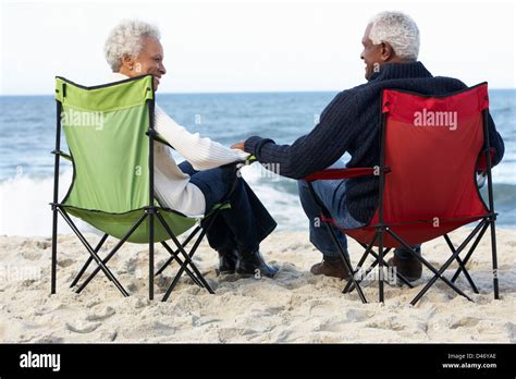 Couple Sitting In Deckchairs On The Beach Hi Res Stock Photography And