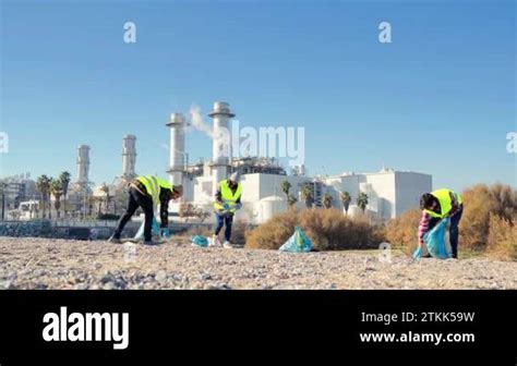 Team Of Environmental Volunteer Activist Picking Up Plastic Trash Of