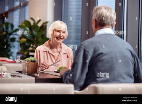 Jolly Mature Woman Having Dinner With Husband Stock Photo Alamy