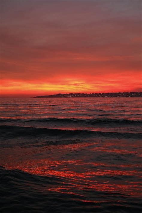 Red Sky at Sunset over Sea Shore · Free Stock Photo