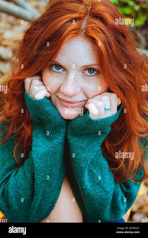 Portrait Of A Beautiful Red Haired Girl With Freckles And Blue Eyes In