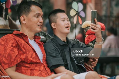 Asian Chinese Down Syndrome Young Man Enjoying Photographing With Smart ...