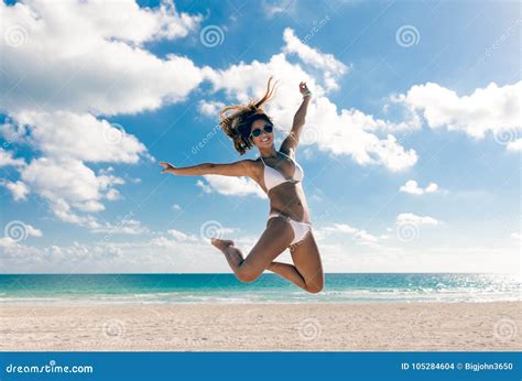 Happy Bikini Asian Woman Jumping Of Joy On Beach Tropical Vacation