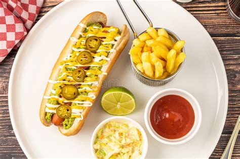 Delicious Hot Dog Sandwich with Sauces and Fries on the Side Stock ...