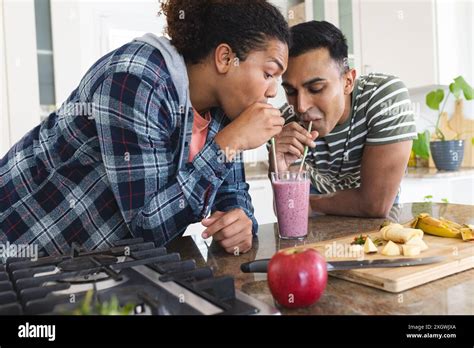 Gay Biracial And Middle Eastern Couple Share A Smoothie At Home They Enjoy A Healthy Lifestyle