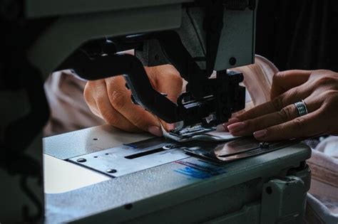 Premium Photo Closeup Shot Of Seamstress Hands Working On Sewing Machine