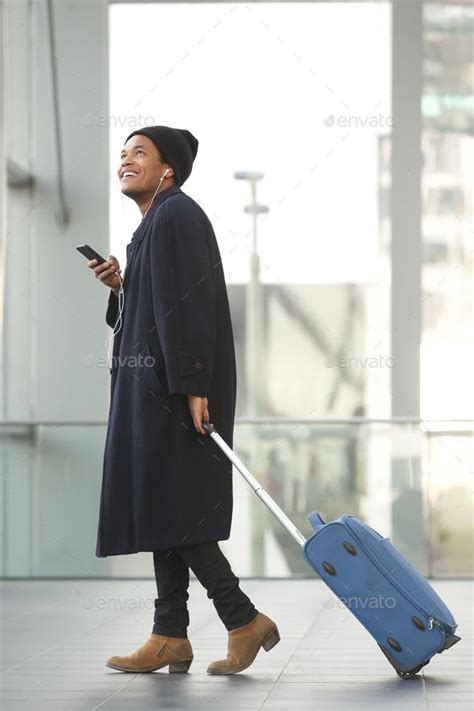 Full Length Happy African American Travel Man Walking At Airport With