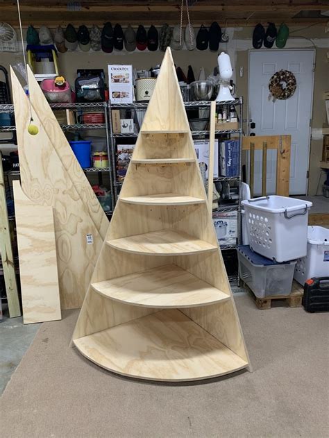 A Wooden Shelf Sitting Inside Of A Shop Next To Other Shelves And Tools