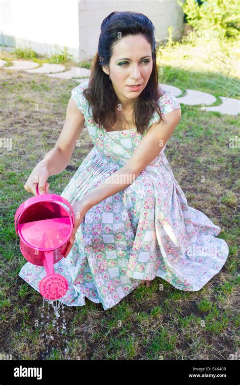 Woman Watering Green Garden Mature Girl Gardening In Her Backyard Spring Season Rural Scene