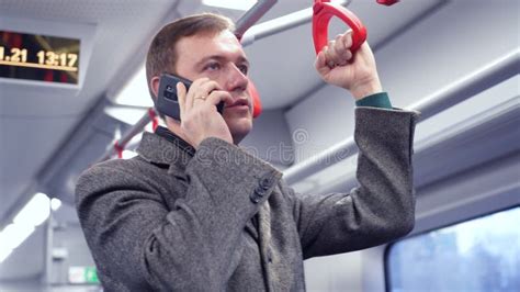 Millennial Man Making Phone Call In Subway Train Guy Commuting To Work