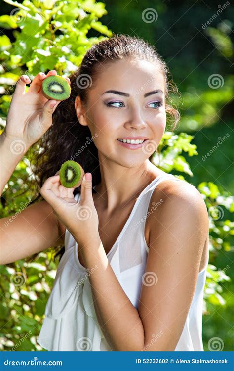 Beautiful Close Up Portrait Of Young Woman With Kiwi Stock Photo