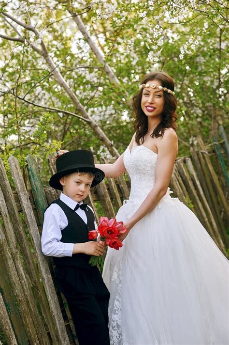 Stylish Boy Is Photographed Together With An Elegant Bride Stock Image