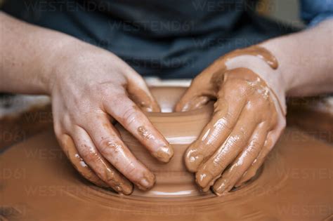 Close Up Of Woman S Hands Molding Clay On Pottery Wheel Stock Photo