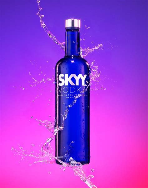 A Blue Bottle With The Sky Vodka Logo On It Is Splashing Out Of Water