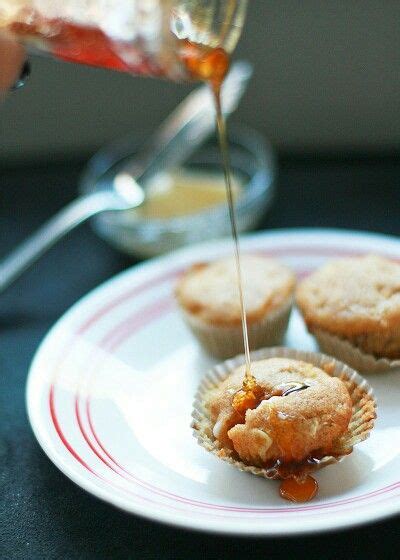 Someone Is Pouring Syrup On Some Muffins That Have Been Placed On A Plate