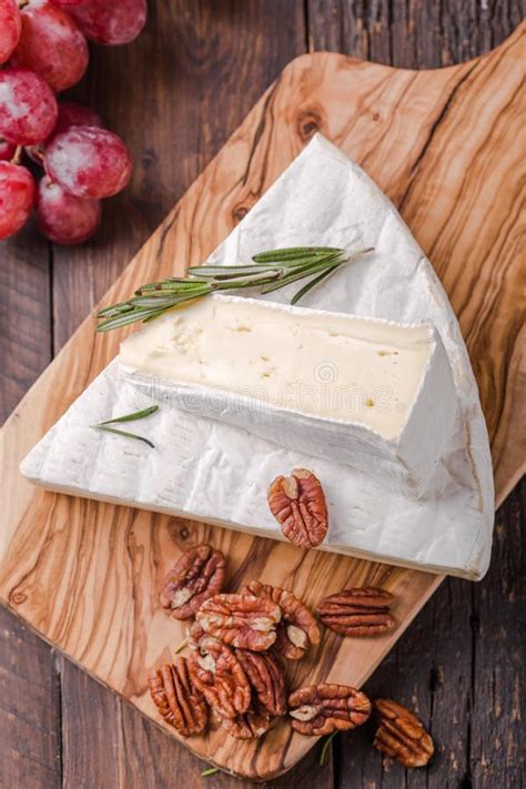 Segment Of Brie Cheese Or Soft Cow S French Camembert On Wooden Board